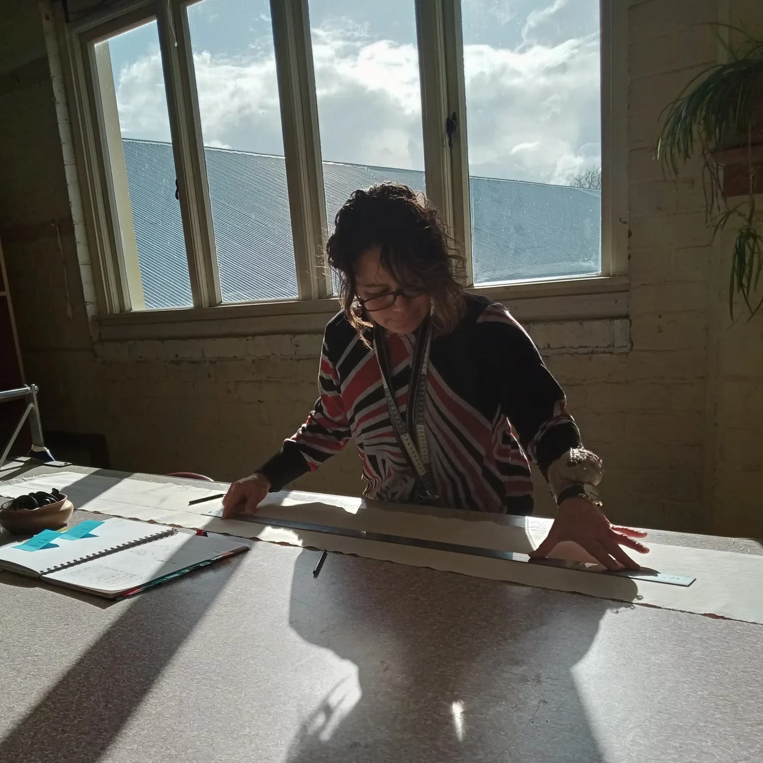 Lee Williams working at the table in Paetuia Studio